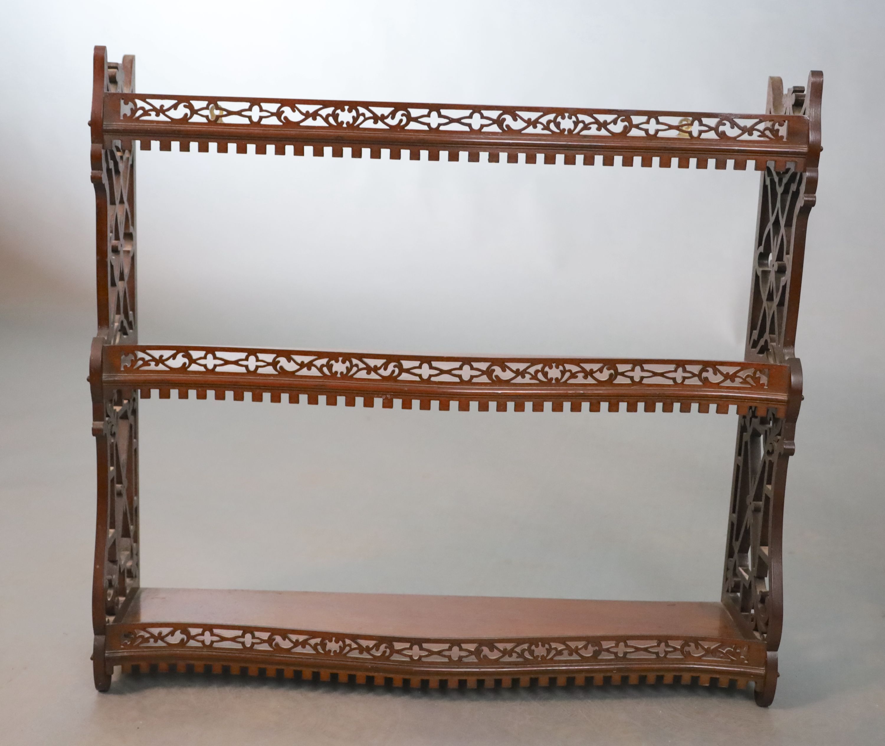 A George II style mahogany three tier wall shelf, W.66cm H.60.5cm